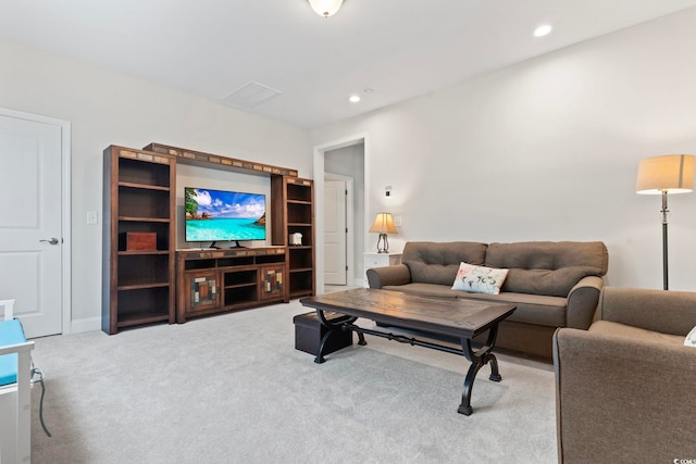 carpeted living area with recessed lighting and baseboards