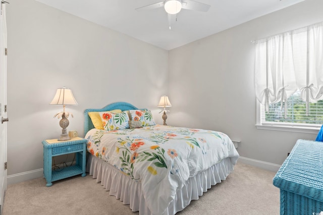 bedroom with a ceiling fan, baseboards, and carpet floors