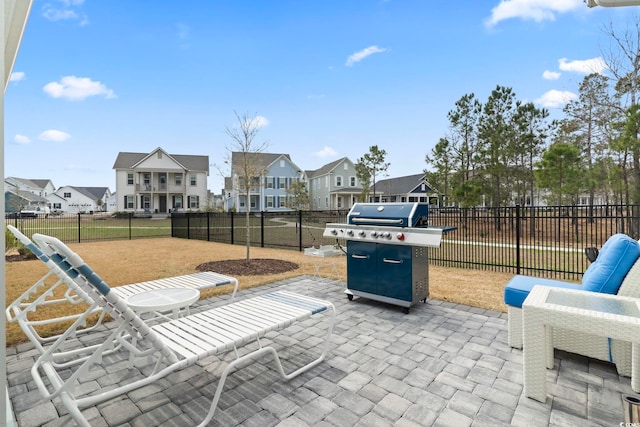 view of patio featuring a residential view, a fenced backyard, and area for grilling