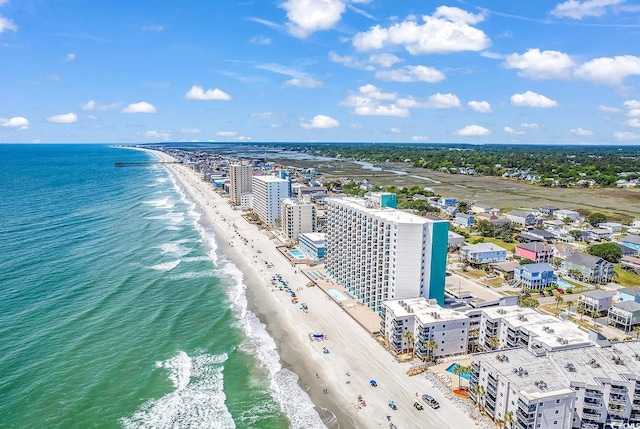 bird's eye view featuring a water view, a city view, and a view of the beach