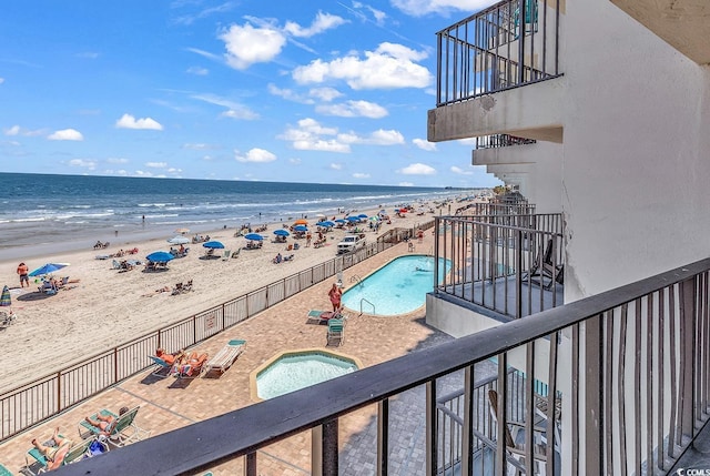 exterior space with a patio area, a view of the beach, and a water view