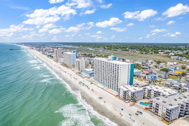 birds eye view of property featuring a water view, a view of city, and a view of the beach