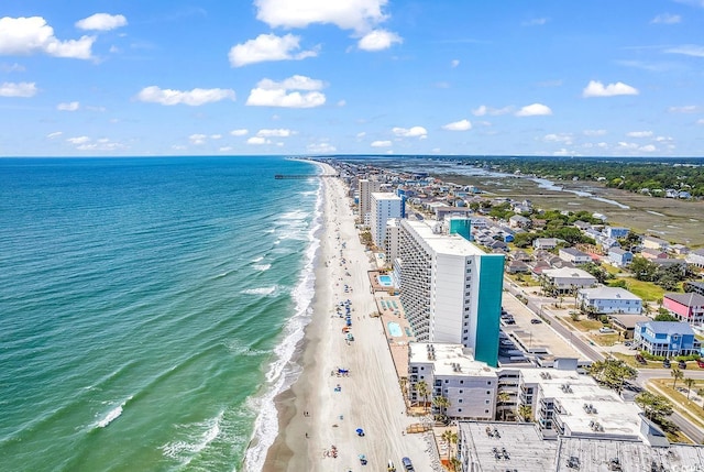 bird's eye view featuring a view of the beach and a water view