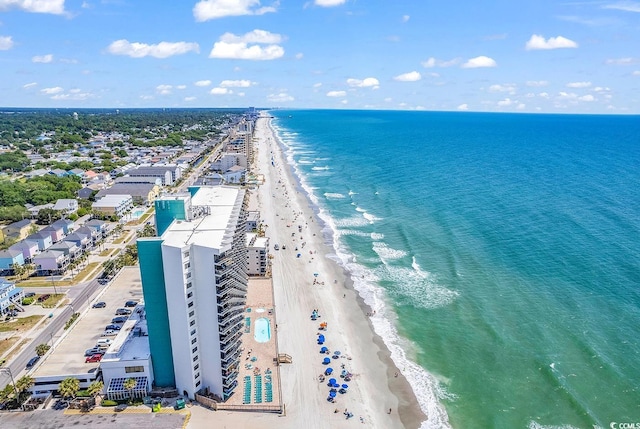 birds eye view of property with a beach view and a water view