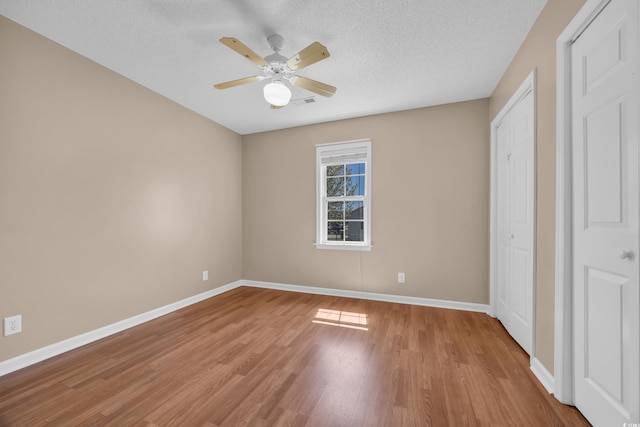 4938 Trooper Ln, Loris, SC 29569 - unfurnished bedroom featuring baseboards, light wood-style floors, a textured ceiling, and a closet