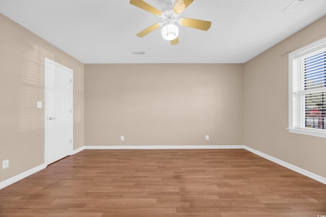 4938 Trooper Ln, Loris, SC 29569 - spare room featuring light wood finished floors, a ceiling fan, and baseboards