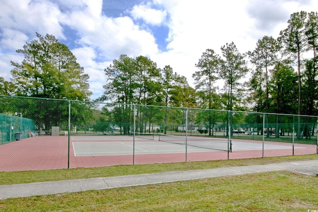 view of sport court featuring a lawn and fence