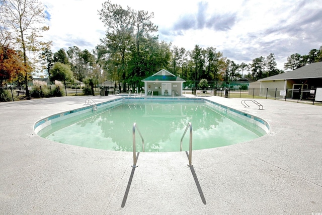 community pool featuring a patio area and fence