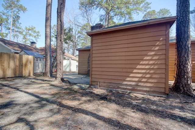 view of outbuilding with an outdoor structure and fence