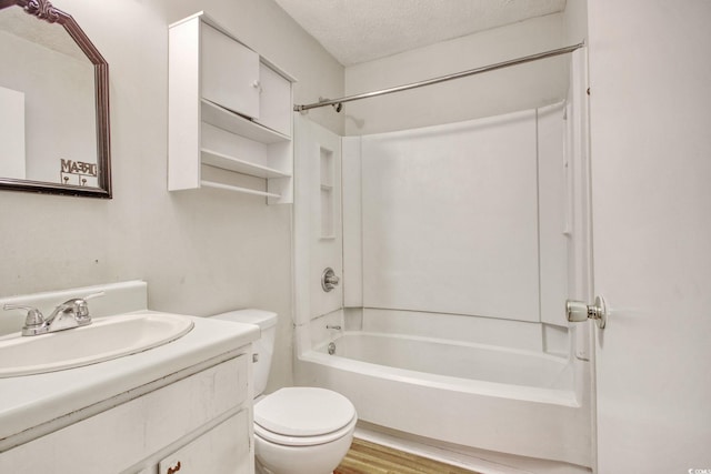 full bathroom with toilet, shower / bathtub combination, a textured ceiling, wood finished floors, and vanity