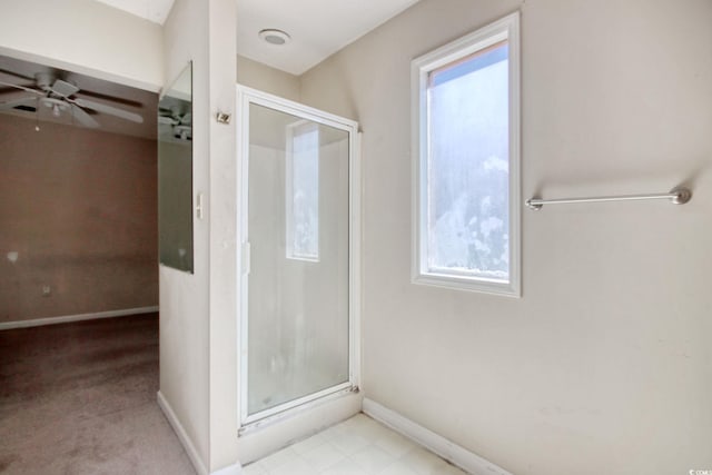 full bathroom with baseboards, a stall shower, and a ceiling fan