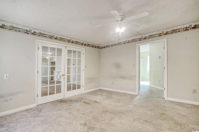 spare room featuring baseboards, carpet, ceiling fan, french doors, and a textured ceiling