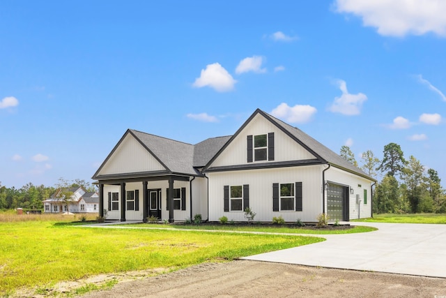 modern inspired farmhouse featuring a garage, a porch, concrete driveway, and a front yard