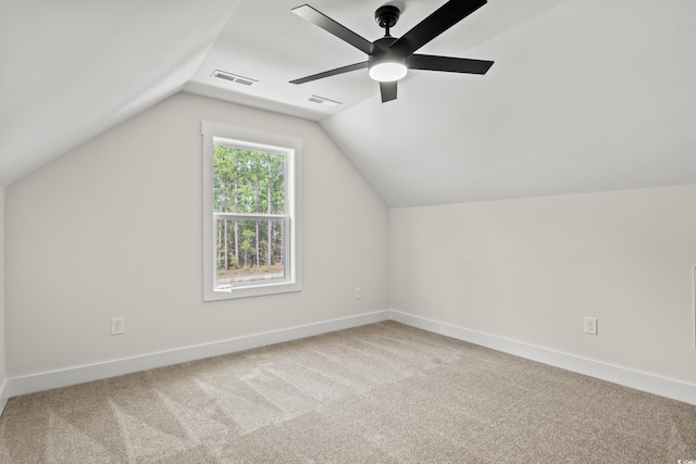 bonus room featuring a ceiling fan, visible vents, carpet floors, baseboards, and lofted ceiling