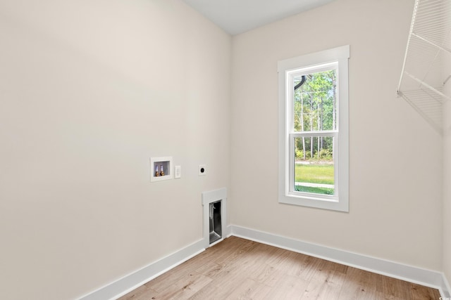 clothes washing area featuring baseboards, washer hookup, laundry area, light wood-style floors, and electric dryer hookup