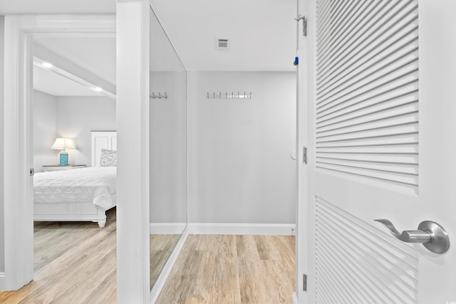 corridor with visible vents and light wood-type flooring