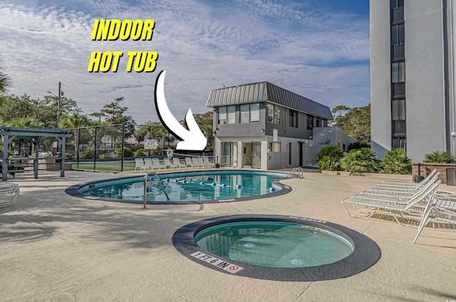 601 Mitchell Dr Unit 203, Myrtle Beach, SC 29577 - community pool featuring a patio, a hot tub, and fence