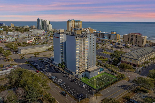 birds eye view of property featuring a city view and a water view