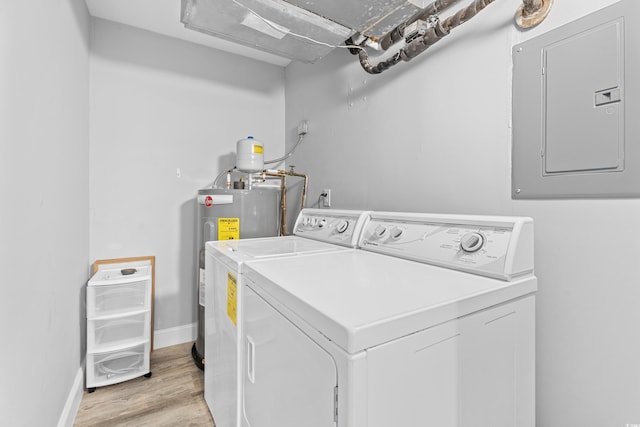 laundry room featuring independent washer and dryer, electric panel, light wood-style floors, baseboards, and laundry area