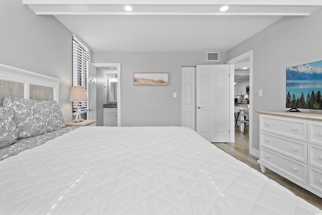 601 Mitchell Dr Unit 203, Myrtle Beach, SC 29577 - bedroom featuring recessed lighting, wood finished floors, and connected bathroom