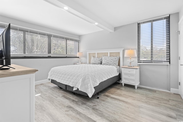 bedroom featuring beamed ceiling, recessed lighting, baseboards, and light wood-style floors