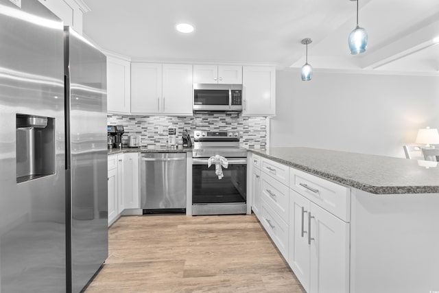 kitchen featuring backsplash, stainless steel appliances, light wood-style floors, and white cabinetry