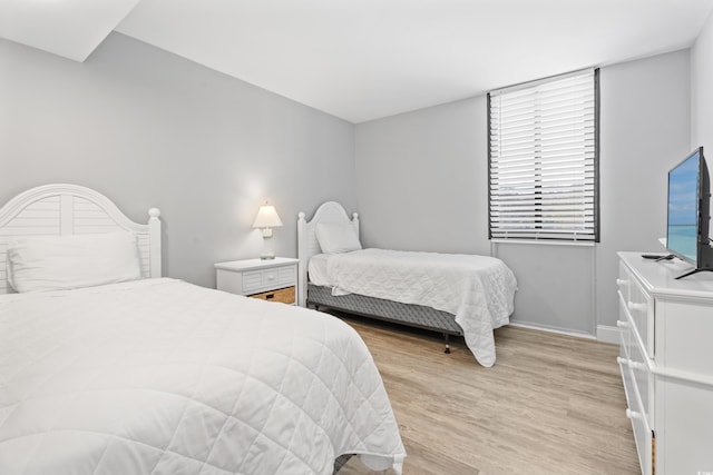 bedroom featuring light wood-style flooring and baseboards