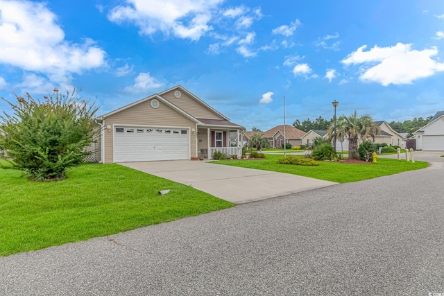 ranch-style home featuring a front yard, an attached garage, covered porch, and driveway