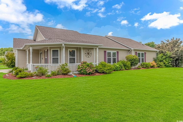 single story home with covered porch, a shingled roof, and a front yard