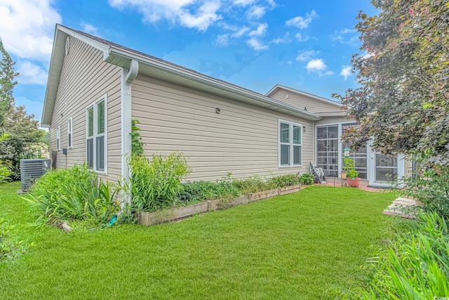 view of home's exterior featuring a yard and cooling unit