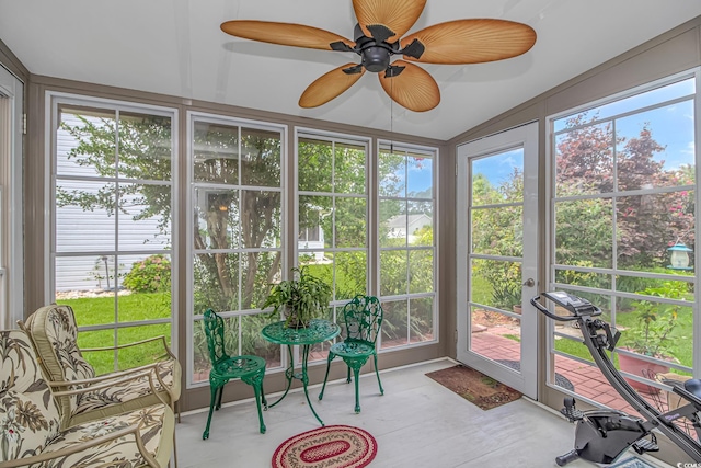 sunroom / solarium with vaulted ceiling, a wealth of natural light, and ceiling fan