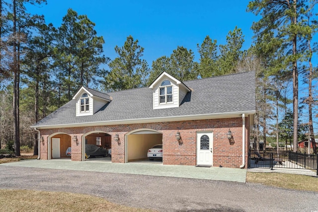 garage featuring fence and driveway