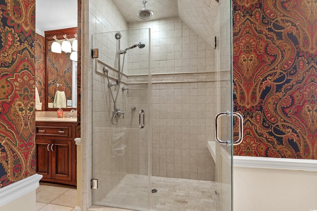 bathroom with a stall shower, vanity, and tile patterned flooring