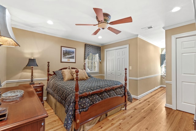 bedroom with visible vents, crown molding, light wood-type flooring, recessed lighting, and a closet