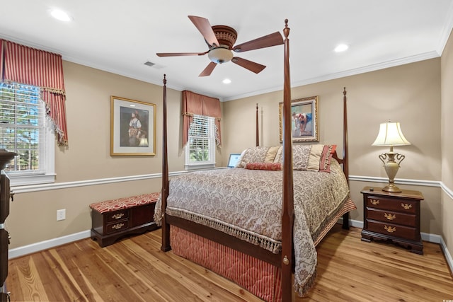 bedroom featuring baseboards, light wood-style floors, and crown molding