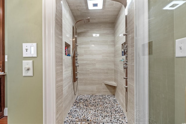 bathroom with tiled shower