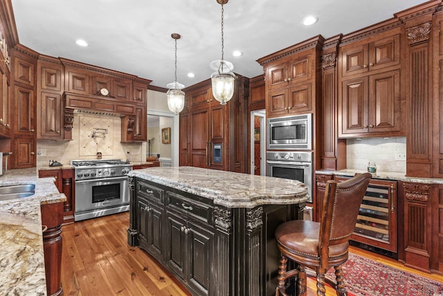 kitchen with tasteful backsplash, beverage cooler, light wood-style flooring, appliances with stainless steel finishes, and a sink