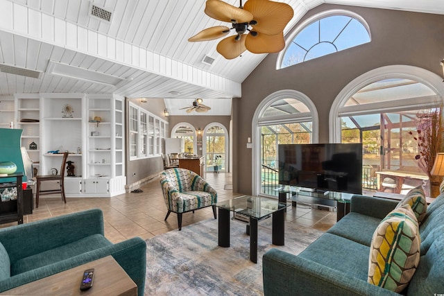 living area featuring tile patterned floors, visible vents, a wealth of natural light, and ceiling fan