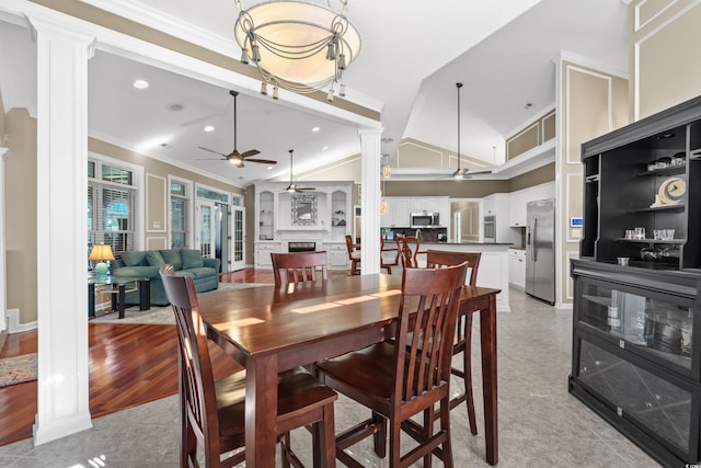 dining space featuring crown molding, ceiling fan, decorative columns, recessed lighting, and a fireplace