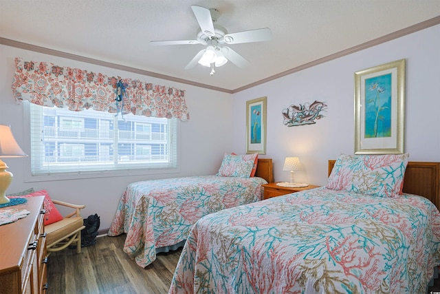 bedroom with ornamental molding, ceiling fan, and wood finished floors