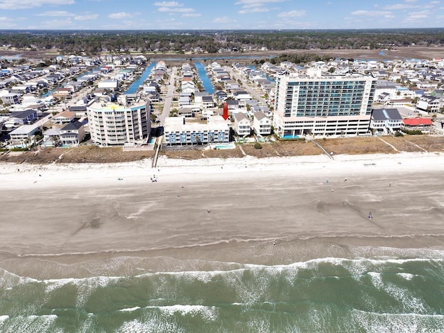 bird's eye view with a water view and a beach view