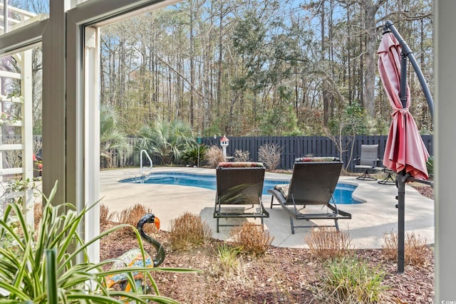 view of swimming pool with a fenced in pool, fence, and a patio area