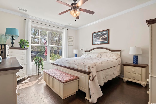 bedroom with ceiling fan, visible vents, ornamental molding, and dark wood finished floors