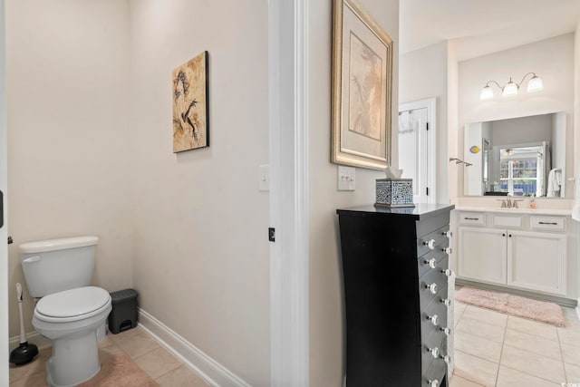 bathroom with tile patterned floors, baseboards, toilet, and vanity