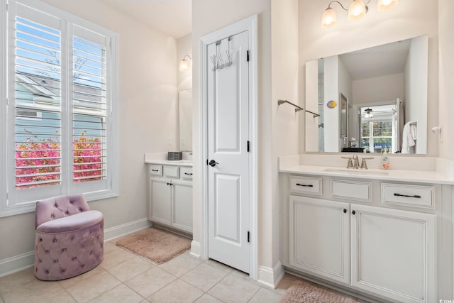 full bathroom featuring vanity, tile patterned floors, and baseboards