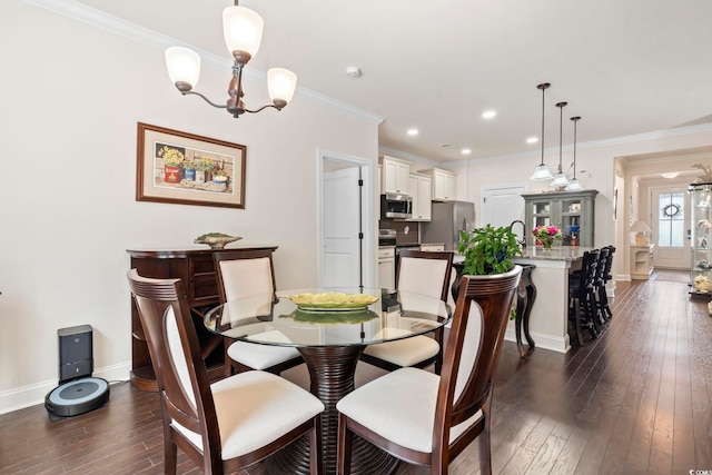 dining space featuring dark wood-type flooring, recessed lighting, crown molding, baseboards, and a chandelier