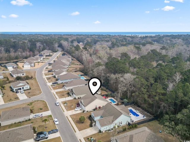 birds eye view of property with a wooded view