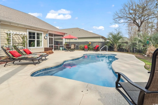 view of swimming pool with a fenced in pool, a patio area, and fence