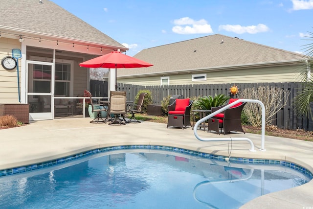 view of pool with a patio, a fenced in pool, and fence