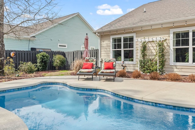 view of swimming pool featuring a fenced in pool, fence, and a patio area